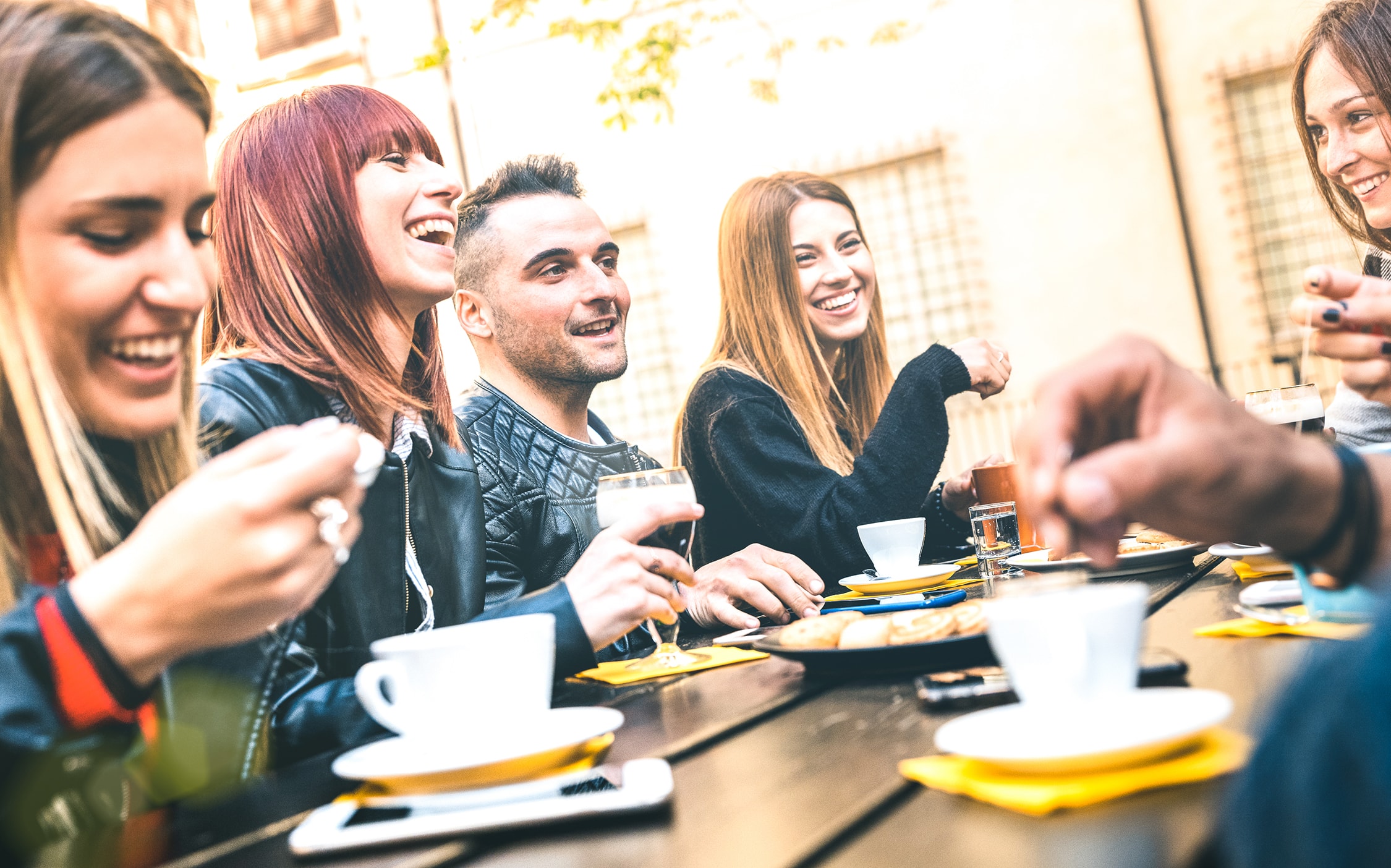 Young adults at a table laughing together